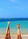 Two women putting their feet up at the beach - tropical vacation , summer concept image