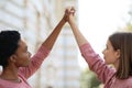 Two women raising hands up, fighting for women rights