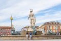 Two women relax in front of the Apollo Statue at the Fountain of the Sun in Place Massena, in the city of Nice France Royalty Free Stock Photo