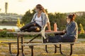 Two women are relaxing at Gravelly Point park at sunset Royalty Free Stock Photo