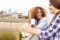 Two Women Relaxing On Rooftop Garden Drinking Coffee Royalty Free Stock Photo