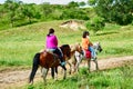 Two women riding horses on the grassland Royalty Free Stock Photo