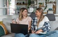 Two women, roommates and business partners, jot down and steal business ideas from the internet about what they can do with their