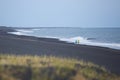 Runners running at black beach