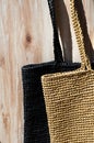 Two women's bags made of raffia black and beige Royalty Free Stock Photo