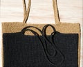 Two women\'s bags made of raffia black and beige Royalty Free Stock Photo