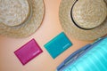 Two women`s beach straw hats, passports and a suitcase on a beige background.  Trip, travel and tourism concept Royalty Free Stock Photo