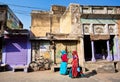 Two women in sari walking down the street