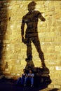 Two women and the shadow of David..Florence, Italy. Royalty Free Stock Photo