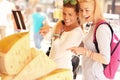 Two women shopping for cheese on food market Royalty Free Stock Photo