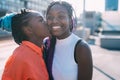 Two women sisters outdoor smiling kissing on the cheeck