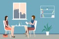 Two women sit at a table in a cozy office. Concept of interview, consultation, insurance, resume submission, business negotiations