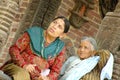 Two women sits near a temple in Durbar square.