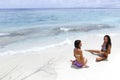 Two women sitting on beach Royalty Free Stock Photo