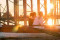 Two women sitting on a boat watching the sunset on the river