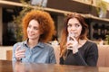 Two women sitting in cafe and drinking water Royalty Free Stock Photo