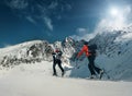 Two women ski walkers go up on the mountain top