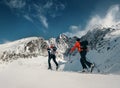 Two women ski walkers go up on the mountain top