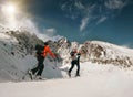 Two women ski walkers go up on the mountain top