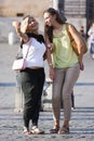 Two women smiling doing a selfie with phone