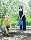 Two women sows seeds Royalty Free Stock Photo