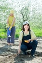 Two women sows seeds Royalty Free Stock Photo