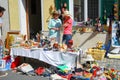 Two women stand behind a table selling used articles