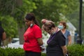 Two women with their heads bowed in prayer