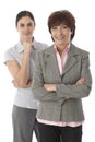 Two women standing arms crossed smiling Royalty Free Stock Photo