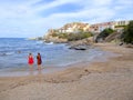 Two women standing at the edge of the sea