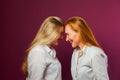 Two women standing opposite each other, touching by heads Royalty Free Stock Photo