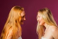 Two women standing opposite each other, touching by heads Royalty Free Stock Photo