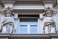 Two women stautes, caryatids, supporting the structure of a window