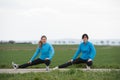 Two women stetching outdoors