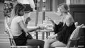 Two women in a street cafe in Paris - PARIS, FRANCE - JULY 29, 2019 Royalty Free Stock Photo