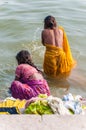 Two women take a bath in the river Ganges