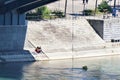 Two women talk privately under bridge