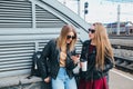 Two Women Talking in the City.Outdoor lifestyle portrait of two best friends hipster girls wearing stylish Leather Royalty Free Stock Photo