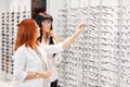 Two women talking about new models of eyeglasses