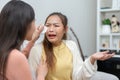 Two women talking about problems at home. Asian women embrace to calm their sad best friends from feeling down. Female friends Royalty Free Stock Photo