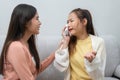 Two women talking about problems at home. Asian women embrace to calm their sad best friends from feeling down. Female friends Royalty Free Stock Photo