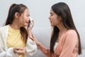 Two women talking about problems at home. Asian women embrace to calm their sad best friends from feeling down. Female friends Royalty Free Stock Photo