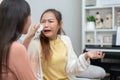 Two women talking about problems at home. Asian women embrace to calm their sad best friends from feeling down. Female friends Royalty Free Stock Photo