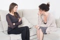 Two women talking on a sofa Royalty Free Stock Photo