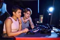 Two women with tattoos concentrating on Royalty Free Stock Photo