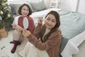 Two women together on a care treatment with face rollers for skin lifting