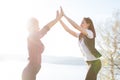 Two women tourist. Hiking people reaching summit top giving high five at mountain top at sunset. Success, achievement Royalty Free Stock Photo