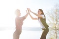 Two women tourist. Hiking people reaching summit top giving high five at mountain top at sunset. Success, achievement Royalty Free Stock Photo