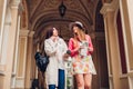 Two women tourists talking while going sightseeing in Odessa. Happy friends travelers using map and drinking coffee Royalty Free Stock Photo