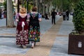 Two women in traditional festive embroidered dresses during the spring festival of Bando de la Huerta in